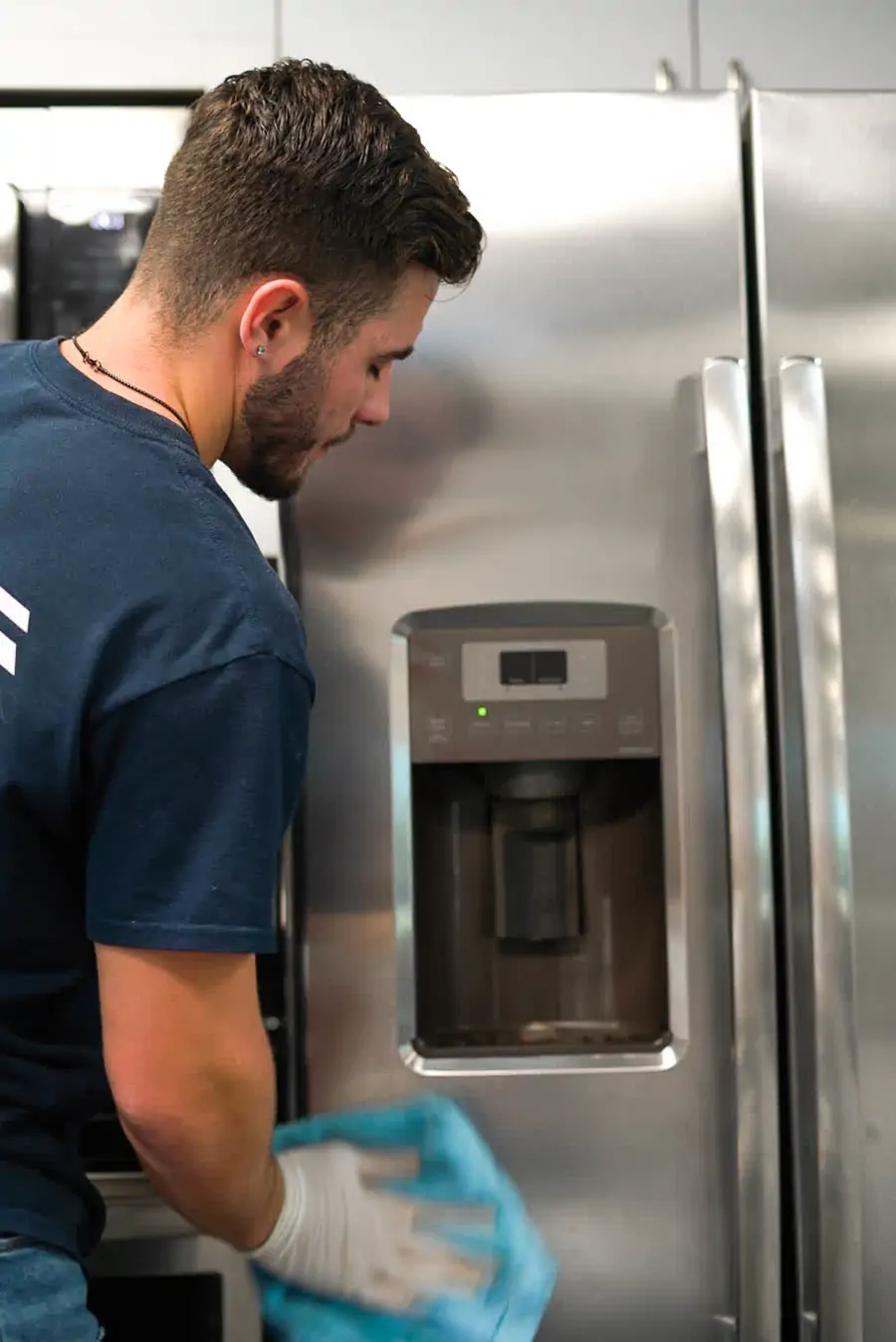 Full Spectrum Services crew detailing kitchen appliances during a turnover clean