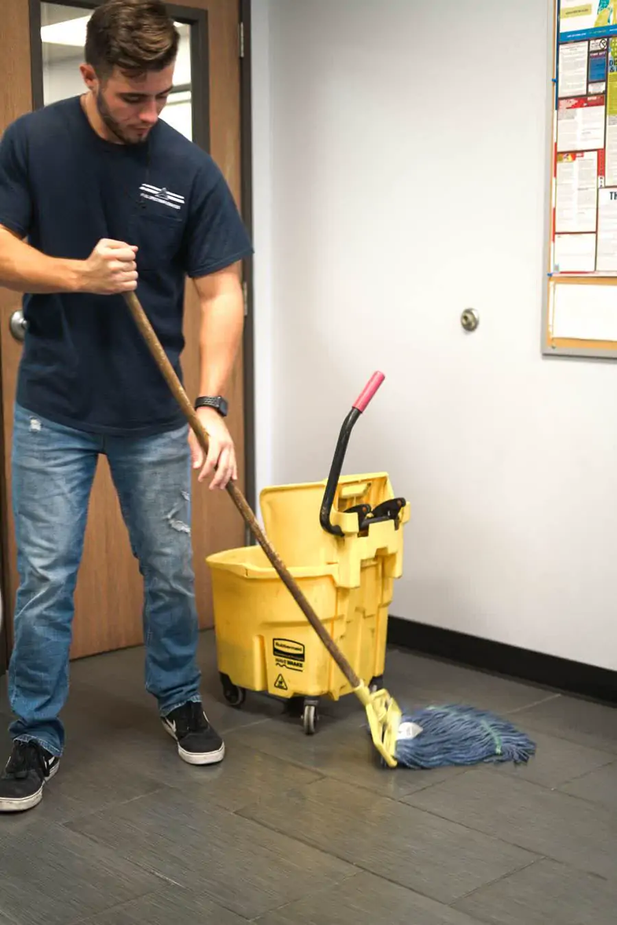 Full Spectrum Services crew member mopping a commercial hard floor